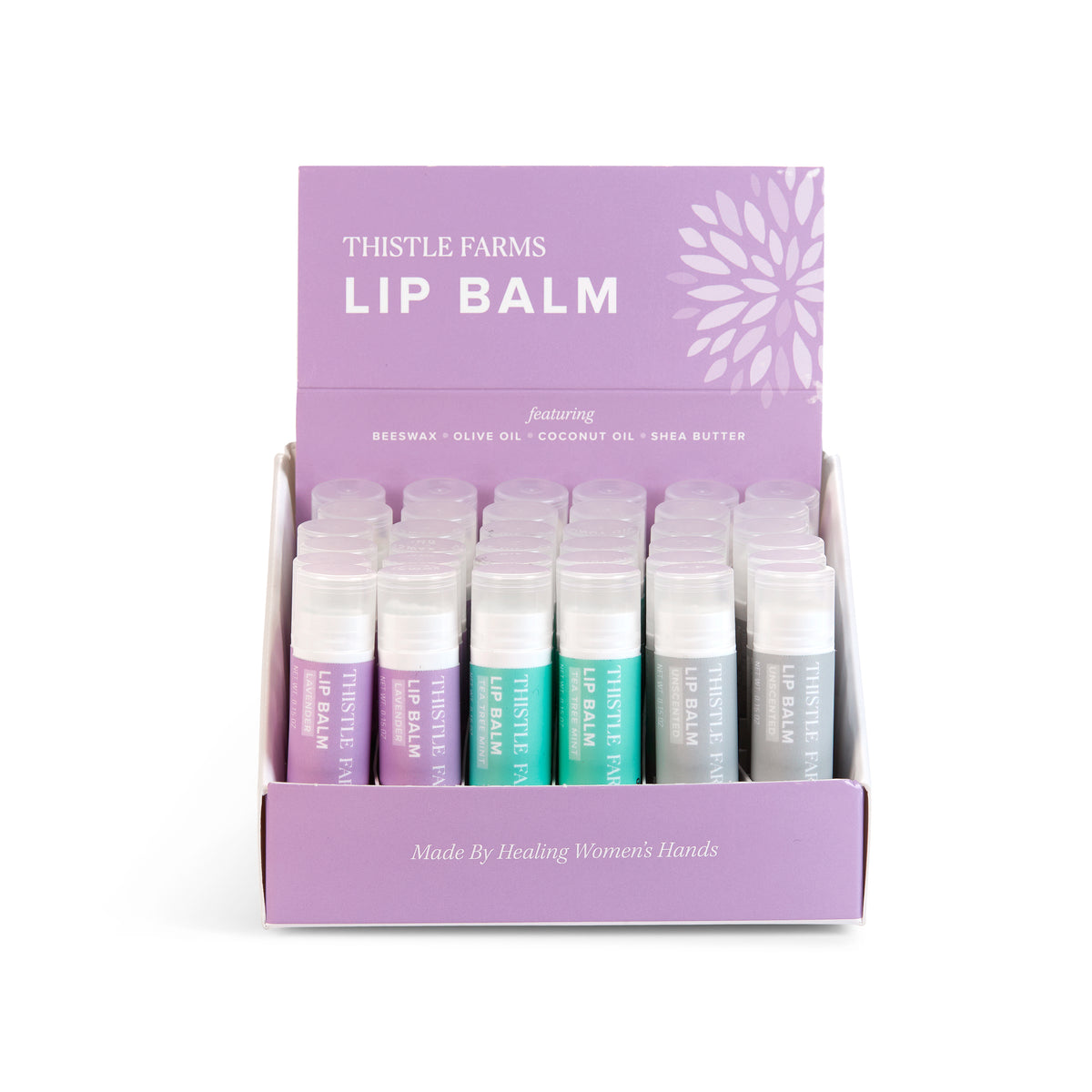 A display box containing multiple tubes of Thistle Farms lip balm in various colors.