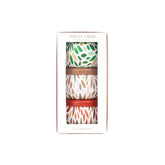 Three patterned candles in a box with 'Thistle Farms' branding on a white background.